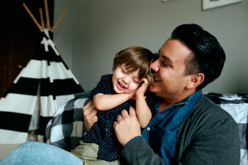 A dad and toddler sun cuddle and smile. Learn more about vaping and tobacco use in Colorado.